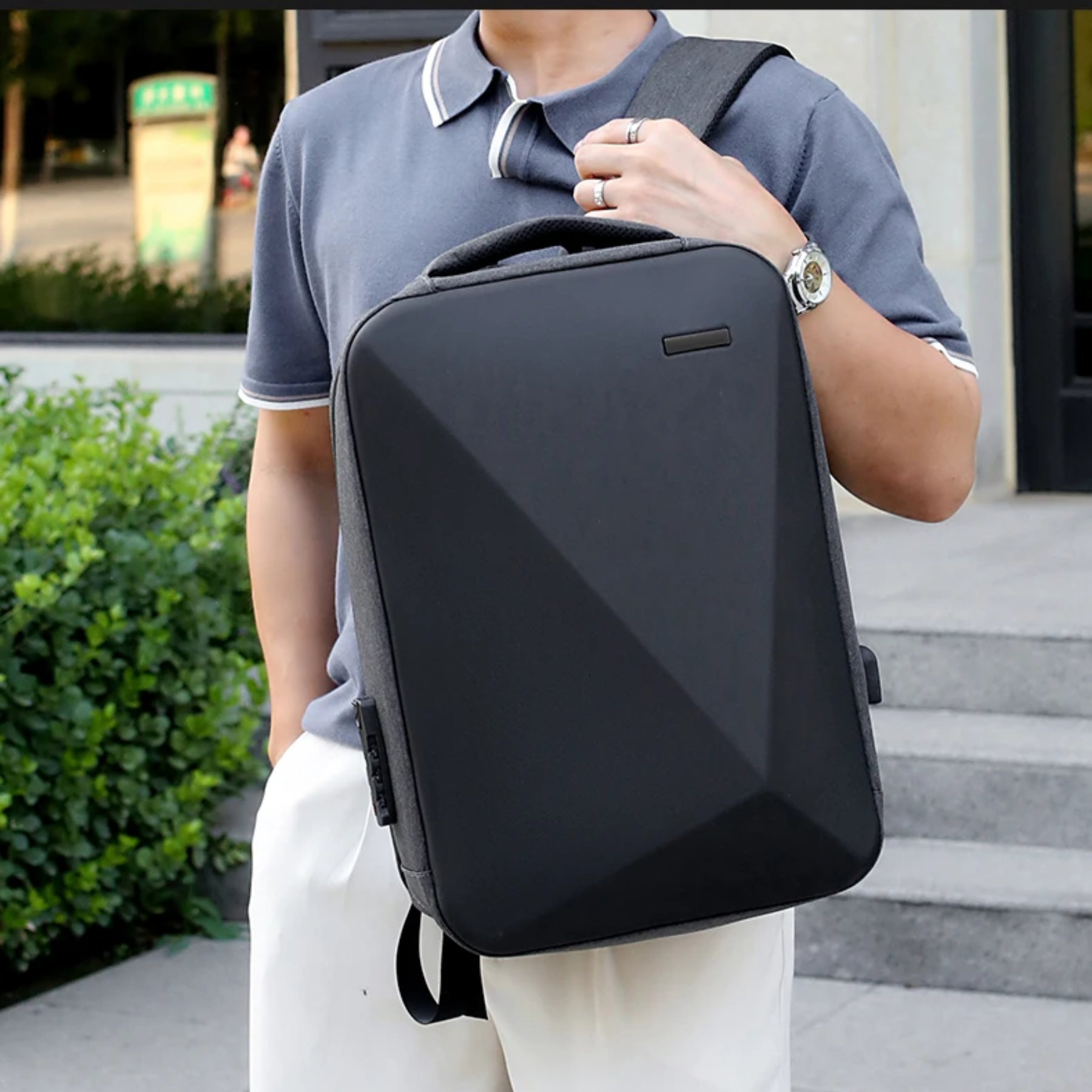 Homem usando mochila TechGuard cinza em ambiente urbano com estilo moderno